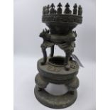 AN ORIENTAL BRONZE STAND OR LAMP BASE WITH MYTHICAL BIRD MASK SUPPORTS. H.30cms.