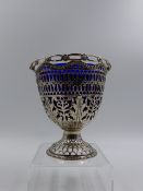 A SILVER HALLMARKED 18th CENTURY PIERCED PEDESTAL BASKET COMPLETE WITH BLUE GLASS LINER, DATED 1773.