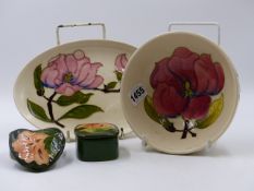 A MOORCROFT POTTERY SMALL BOWL. Dia.16cms. AN OVAL DISH. 23 x 7cms. A HEART SHAPED LIDDED TRINKET