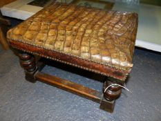 AN EARLY VICTORIAN CROCODILE HIDE COVERED FOOTSTOOL