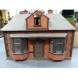 A LARGE EDWARDIAN DOLL'S HOUSE WITH DOUBLE BAY WINDOWS.