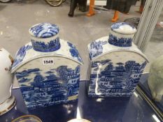 A PAIR OF BLUE AND WHITE PAGODA PATTERN LIDDED TEA CADDIES. H.31cms. TOGETHER WITH A PAIR OF CHINESE