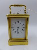 AN ANTIQUE BRASS CASED FIVE GLASS CARRIAGE CLOCK WITH WHITE ENAMEL DIAL SIGNED J W BENSON, 8-DAY