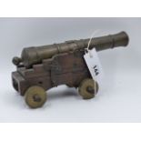 A 19th.C.BRONZE MODEL CANNON ON HAND MADE STEPPED CARRIAGE WITH ADJUSTABLE ELEVATION.