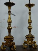 A PAIR OF ANTIQUE HEAVY FLEMISH BRASS PRICKET CANDLESTICKS NOW MOUNTED AS LAMPS. OVERALL H.64cms.