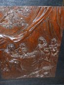 AN ANTIQUE CARVED OAK PANEL DEPICTING A ROYAL AND SERVANTS TOGETHER WITH A FRAMED EMBOSSED LEATHER