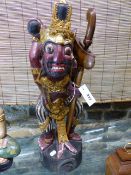 A JAVANESE FIGURE OF A DEMON WARRIOR MOUNTED WITH KRIS WITH WAVY DAMASCENE BLADE CONTIANED IN WOOD
