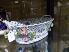 A DRESDEN TWO HANDLED BASKET PAINTED WITH ENCRUSTED FLOWERS. L.31cms. H.12cms.