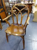 AN INTERESTING YEW WOOD AND ELM WINDSOR ARMCHAIR WITH CRINOLINE STRETCHER.