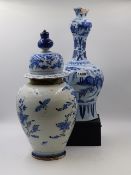 A CONTINENTAL DELFT POTTERY VASE WITH ELONGATED NECK DEPICTING AN ORIENTAL PAINTED SCENE. H.38cms