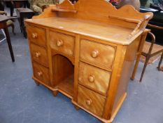 A VICTORIAN SATINWOOD GALLERY BACK WASHSTAND WITH ARRANGEMENT OF SEVEN DRAWERS AND RECESSED