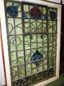 AN IMPRESSIVE ART NOUVEAU STAINED GLASS WINDOW WITH OPENING TOP CENTRE PANEL AND PAINTED WOOD FRAME.