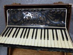 A VINTAGE UNSIGNED PIANO ACCORDIAN IN A PROTECTIVE CASE TOGETHER WITH AN H.M.V. PORTABLE