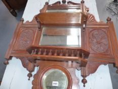 A VICTORIAN MAHOGANY HALL MIRROR WITH CARVED DECORATION. W.76cms.