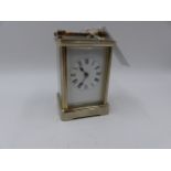 AN EARLY 20th.C.SILVERED BRASS CASED STRIKING CARRIAGE CLOCK WITH WHITE ENAMEL DIAL, THE MOVEMENT