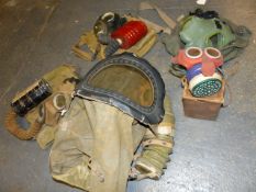 A MICKEY MOUSE GAS MASK AND BOX, FOUR CIVILIAN GAS MASKS, A BABY'S GAS MASK, THREE MILITARY GAS