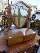 AN ANTIQUE MAHOGANY SHIELD FORM SWING MIRROR.