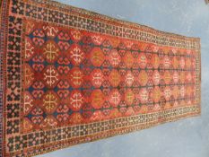 A TRIBAL ORIENTAL RUG OF CAUCASIAN DESIGN. 340 x 147cms.