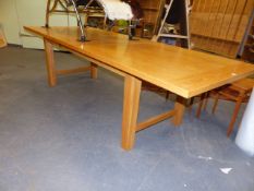 A GOOD QUALITY HEAL'S OAK EXTENDING DINING TABLE AND TWELVE LADDER BACK RUSH SEAT CHAIRS.