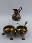A HALLMARKED SILVER CREAMER, SPOON AND TWO SALTS WITH GILDED INNERS. TOTAL APPROXIMATE WEIGHT