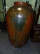 A LARGE ORIENTAL BROWN GLAZE STORAGE JAR. H.74cms.