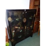 A CHINESE BLACK LACQUER TWO DOOR CABINET WITH POLYCHROME LANDSCAPE DECORATION. H.137 x W.107cms.