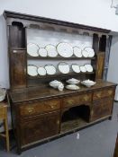 AN 18th.C.AND LATER OAK AND MAHOGANY BANDED DRESSER WITH THREE DRAWER BASE OVER TWO CUPBOARDS AND