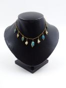 A PRECIOUS YELLOW METAL TURQUOISE AND PEARL MULTI STONE DROP NECKLACE. THE NECKLACE CONSISTS OF FIVE