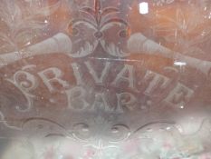 AN ANTIQUE ETCHED GLASS PANEL, PRIVATE BAR.