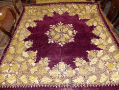 TWO EASTERN EMBROIDERED PANELS, ONE IN METAL THREAD ON A WINE RED GROUND.