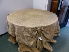 A BESPOKE DESIGNER ROUND TABLE COVERED AND DRAPED ON AN ITALIANATE FABRIC.H.84 x Dia.150cms.