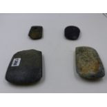 FOUR EARLY CHINESE STONE IMPLEMENTS (CELTS). LARGEST 13 x 10cms.