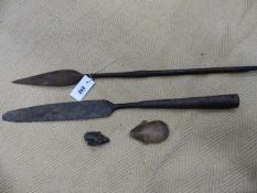 TWO AFRICAN IRON SPEAR HEADS AND TWO SMALL CARVED WOODEN MASKS. (4)