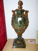 A PAIR OF GREEN MARBLE ORMOLU MOUNTED TWIN HANDLE FRENCH URNS. H.49cms.