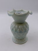 AN EARLY CHINESE CELADON GLAZE BALUSTER VASE WITH TURNED DOWN PETAL RIM AND MOULDED DECORATION. H.