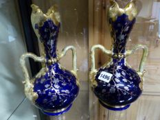 A PAIR OF SARRAGUIMES TWO HANDLED VASES. H.26cms.