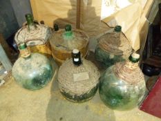 A QTY OF VINTAGE GLASS CARBOYS.