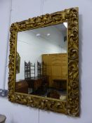 A VICTORIAN CARVED GILTWOOD FRAMED WALL MIRROR. W.77 x H.91cms.
