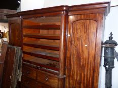 A LARGE VICTORIAN MAHOGANY LINEN PRESS WARDROBE FITTED WITH SLIDES OVER FOUR DRAWERS FLANKED BY
