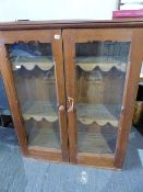 AN ANTIQUE PINE GLAZED CABINET FORMERLY A GUN CABINET, NOW FITTED WITH SHELVES. W.190 x H.135cms.