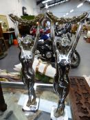 A PAIR OF SILVERED ART DECO STANDS WITH SUPPORTS IN THE FORM OF STANDING NUDES WITH UPSTRETCHED