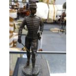 A CONTINENTAL BRONZE FIGURE OF A SOLDIER DRAWING HIS SWORD. H.37cms.