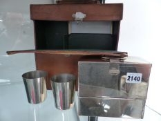 A VINTAGE MOTORING LEATHER CASED PICNIC SET.