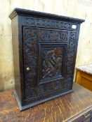 AN 18th.C.OAK WALL CUPBOARD WITH CARVED DECORATED PANEL DOOR AND SHELVED INTERIOR. W.47 x H.57cms.
