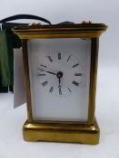 A SWISS MADE BRASS CASED CARRIAGE CLOCK WITH WHITE ENAMEL DIAL, THE SIDES WITH PICTORIAL PANELS