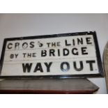 A VINTAGE RAILWAY CROSS THE LINE BY THE BRIDGE SIGN.