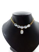 A 14ct YELLOW GOLD MOONSTONE NECKLACE. THE SIX OVAL MOONSTONES ARE IN INDIVIDUAL FOUR CLAW SETTINGS,