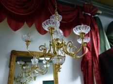 A GOOD QUALITY BRASS AND CRYSTAL SIX LIGHT CHANDELIER, SCROLL FORM ARMS. H.70cms. Dia. 74cms.