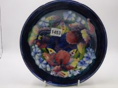 A WILLIAM MOORCROFT FRUIT BOWL DECORATED WITH FLOWERS. Dia.22cms.
