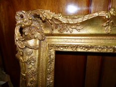 A FRENCH STYLE SWEPT GILT FRAME OF LARGE SIZE, REBATE 148 x 90cms.